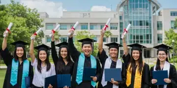 Graduates celebrating with diplomas on a university campus, symbolizing successful educational savings.