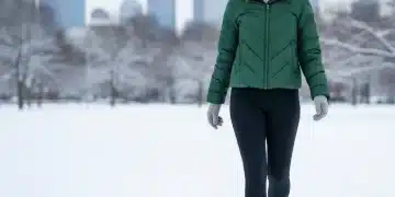 Woman in winter athleisure walking through snowy park
